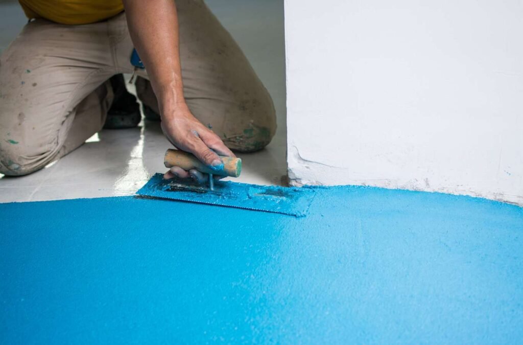 Professional installers from Expert Epoxy Solutions meticulously applying epoxy flooring in a Wrightsville home, illustrating their expertise and precision. Residential Expoxy Flooring Near Me.