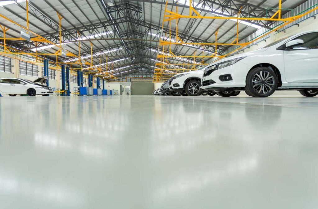 A wide-angle view of a modern garage featuring sleek, high-gloss epoxy flooring by Expert Epoxy Solutions in Wrightsville, NC, setting a professional tone for the webpage.
