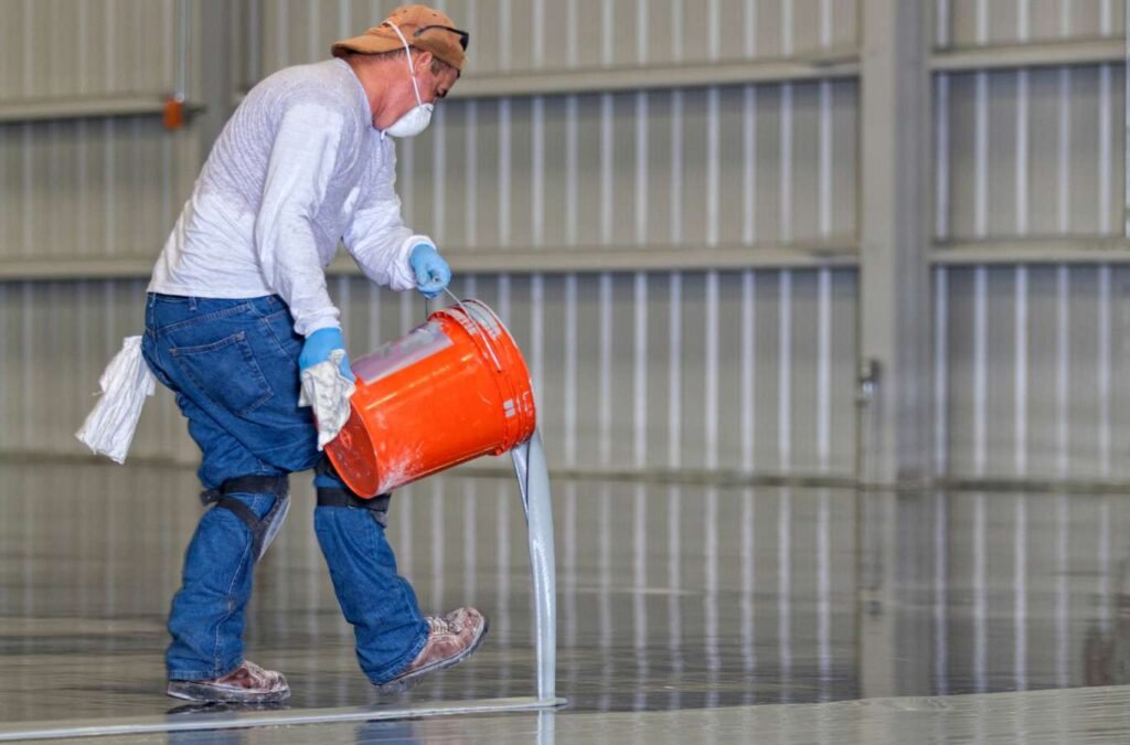 A team of skilled technicians from Expert Epoxy Solutions applying epoxy flooring in a Wrightsville garage, demonstrating expertise and attention to detail. Garage Epoxy Flooring Near Me.