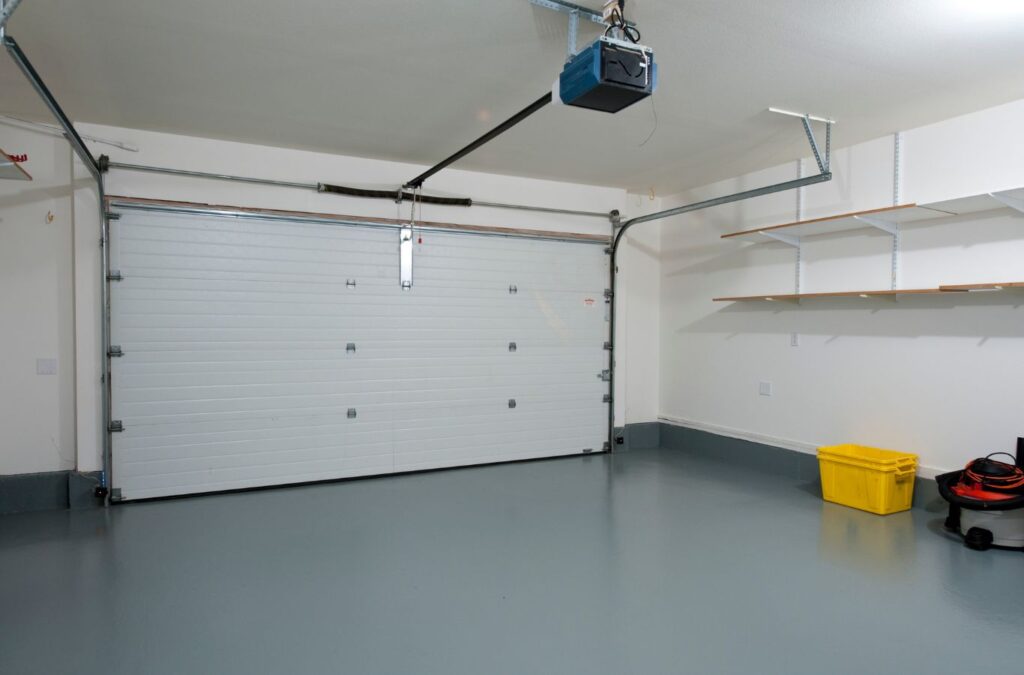 A professional from Expert Epoxy Solutions installing epoxy flooring in a garage in Wilmington, NC. Enhance your garage's durability and look with our expert services.